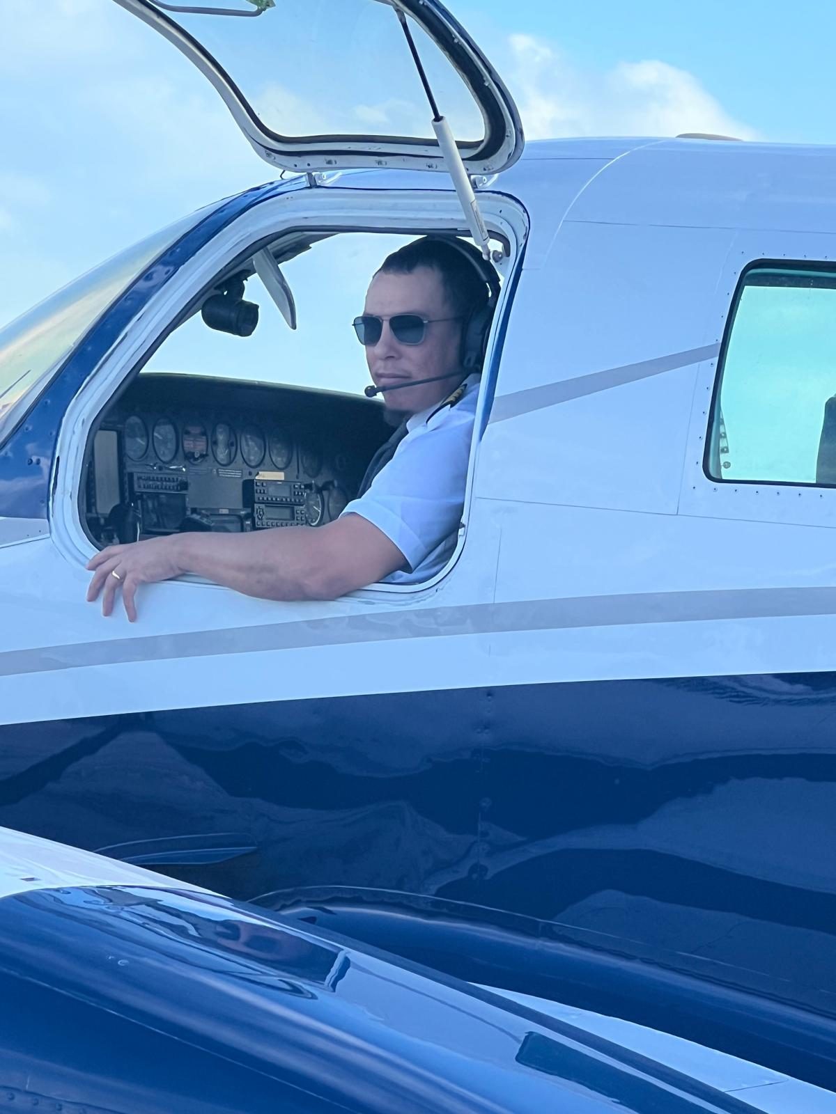 Pilot at the open cockpit window of the Graceful Wings aircraft