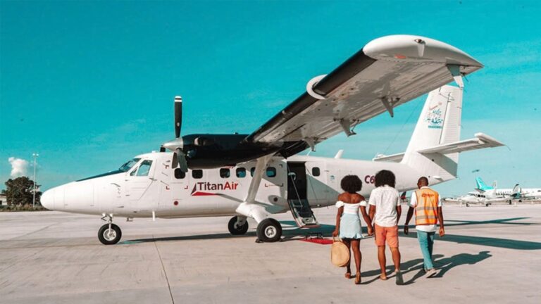 Passengers walking to a Titan Air plane on the tarmac
