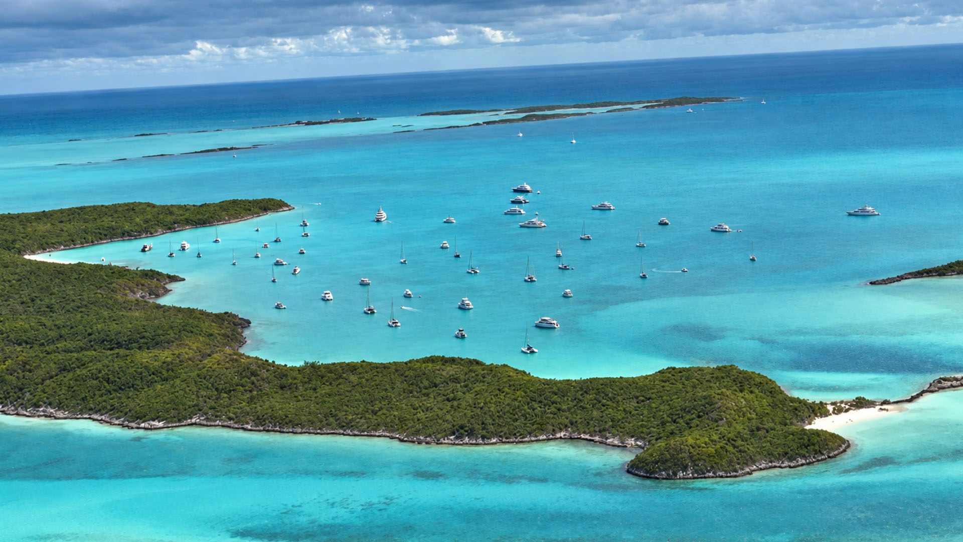 Aerial view of Staniel Cay's harbor with anchored boats