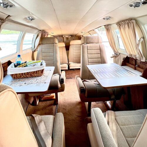 Charter plane cabin with leather seats and tables