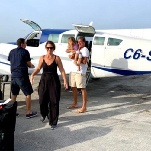 Passengers with their luggage beside the aircraft on the apron